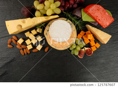 Cheese plate of color cheeses variety, yellow, white and blue cheese board, assorted dairy products Cheese plate of color cheeses variety, yellow, white and blue cheese board, assorted dairy products 125787607