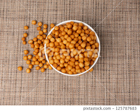 Small pastry balls, fried crispy wheat soup pearls, salad egg puffs or choux pastry 125787683