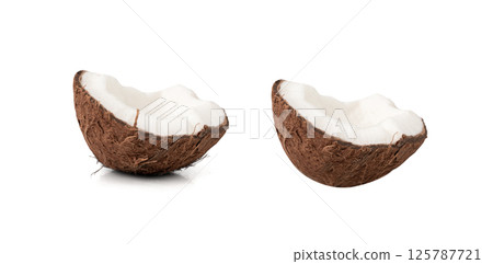 Coconut pieces, broken coco nut isolated, fresh tropical palm fruit slices, open cracked coconut 125787721