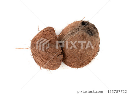 Coconut pieces, broken coco nut isolated, fresh tropical palm fruit slices, open cracked coconut 125787722