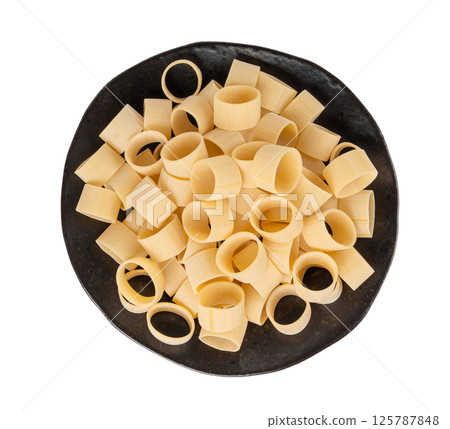 Raw Calamarata Big Pasta Isolated, Homemade Dry Macaroni, Italian Raw Round Noodle 125787848