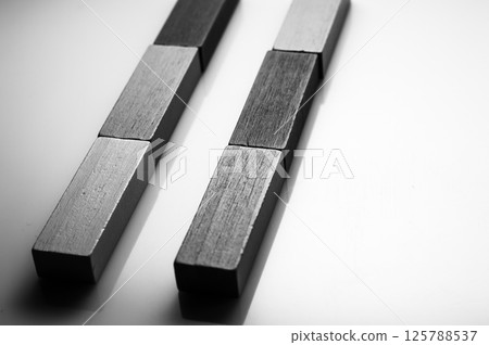 Wooden educational toys are presented as a stylish composition on a white background. Play blocks showcase the natural texture of the material even without color. 125788537