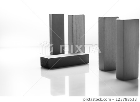 Wooden educational toys are presented as a stylish composition on a white background. Play blocks showcase the natural texture of the material even without color. 125788538