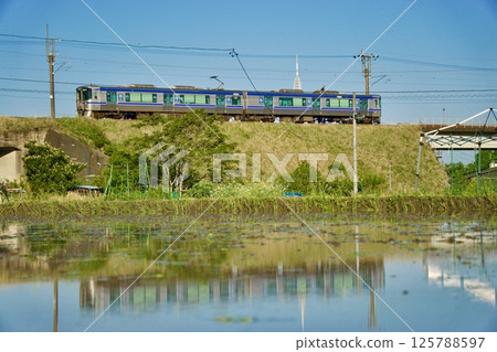 Aichi Loop Railway train and water filling before rice planting Aichi Loop Railway train and water filling before rice planting 125788597