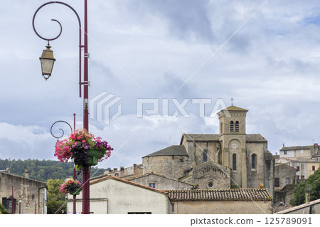 Saint Hilaire Abbey church rising over stone wall in Aude, France Saint Hilaire Abbey church rising over stone wall in Aude, France 125789091