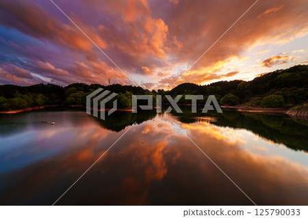 Dynamically changing scenery in the evening sky after the rain. Burning sky. South side toward Lake Nunome. At Nara Nunome Dam. 125790033