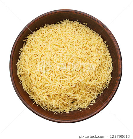 Filini raw pasta in clay bowl isolated on white background. File contains clipping path. 125790613