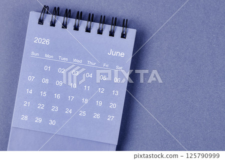 June 2026 Monthly desk calendar for 2026 year on blue background. June 2026 Monthly desk calendar for 2026 year on blue background. 125790999