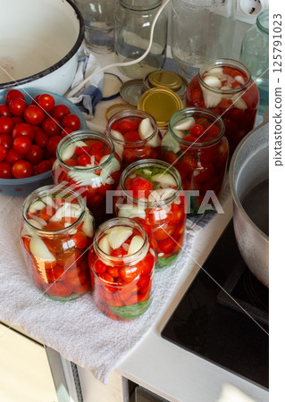 Preserving fresh tomatoes and tomato juice for the winter, stored in airtight jars for long-term use Preserving fresh tomatoes and tomato juice for the winter, stored in airtight jars for long-term use 125791023
