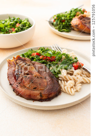 Enjoy a hearty meal with turkey paired with gluten-free pasta and a fresh salad of seasonal vegetables and herbs, complemented by ripe fruits for a balanced and nutritious breakfast or lunch Enjoy a hearty meal with turkey paired with gluten-free pasta and a fresh salad of seasonal vegetables and herbs, complemented by ripe fruits for a balanced and nutritious breakfast or lunch 125791056