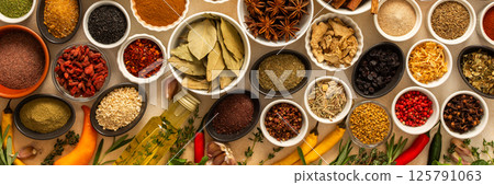 Collection of assorted spices and herbs spread on a beige background, blending exotic aromas and colors to inspire flavorful cooking, banner Collection of assorted spices and herbs spread on a beige background, blending exotic aromas and colors to inspire flavorful cooking, banner 125791063