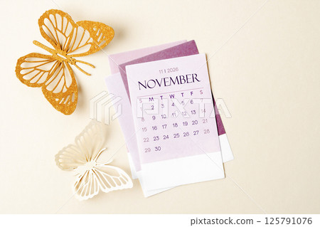 November 2026 calendar page with craft paper cutting butterfy shape. November 2026 calendar page with craft paper cutting butterfy shape. 125791076