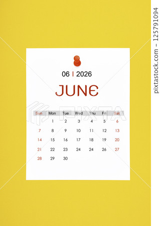 June 2026 calendar page with push pin on yellow background. 125791094