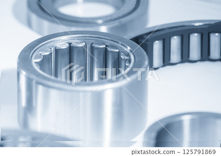 Close up scene the needle rolling bearing parts in the light blue scene. Close up scene the needle rolling bearing parts in the light blue scene. 125791869