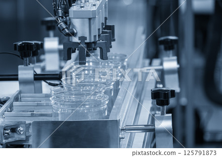 The high technology material handling process from injection machine by robotic system. The high technology material handling process from injection machine by robotic system. 125791873