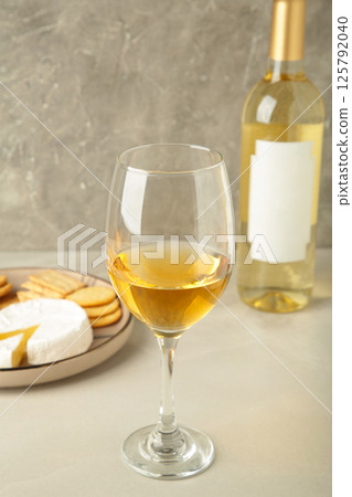 Wine tasting. Parmesan cheese with glass of wine on light background. Cheese plate. Wine card, restaurant menu. Wine tasting. Parmesan cheese with glass of wine on light background. Cheese plate. Wine card, restaurant menu. 125792040