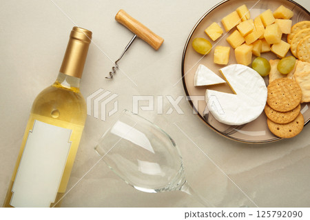 Wine tasting. Parmesan cheese with glass of wine on light background. Cheese plate. Wine card, restaurant menu. Wine tasting. Parmesan cheese with glass of wine on light background. Cheese plate. Wine card, restaurant menu. 125792090
