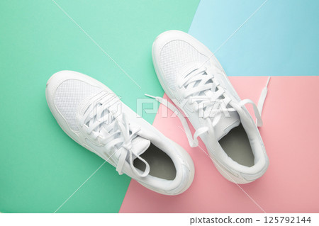 White sneakers on colorful background. Space for text 125792144