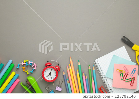 Studio shot of school supplies on grey background. Space for text Studio shot of school supplies on grey background. Space for text 125792146