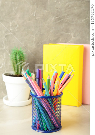 School accessories concept. Photo of stationery on grey background. Vertical photo 125792170