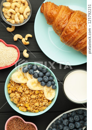 Healthy breakfast set on black background. Granola with fresh summer berries. Vertical photo Healthy breakfast set on black background. Granola with fresh summer berries. Vertical photo 125792231