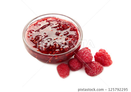 Raspberry jam jelly in bowl with berries isolated on white background. Raspberry jam jelly in bowl with berries isolated on white background. 125792295