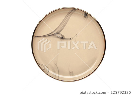 Empty beige ceramic plate isolated on white background. Top view, copy space, flat lay. Empty beige ceramic plate isolated on white background. Top view, copy space, flat lay. 125792320