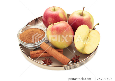 Apples with spices: cinnamon, star anise on plate isolated on white background 125792592