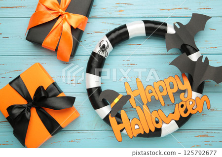 Halloween wreath with gift on blue wooden background. Thanksgiving decor. 125792677