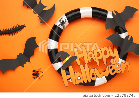 Halloween wreath on orange background. Thanksgiving decor. Top view 125792743