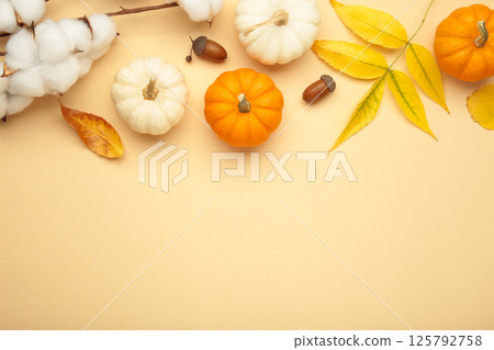 Autumn composition. Fresh orange and white pumpkin with autumn leaves on beige background. Autumn composition. Fresh orange and white pumpkin with autumn leaves on beige background. 125792758
