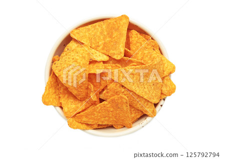 Crispy corn tortilla nachos chips in bowl isolated on white background Crispy corn tortilla nachos chips in bowl isolated on white background 125792794