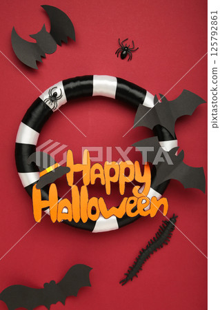 Halloween wreath on red background. Thanksgiving decor. Vertical photo Halloween wreath on red background. Thanksgiving decor. Vertical photo 125792861