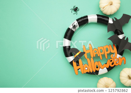 Wreath on mint background with white pumpkin, Halloween holiday. Thanksgiving decor. Wreath on mint background with white pumpkin, Halloween holiday. Thanksgiving decor. 125792862