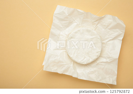 Camembert cheese on beige background. 125792872