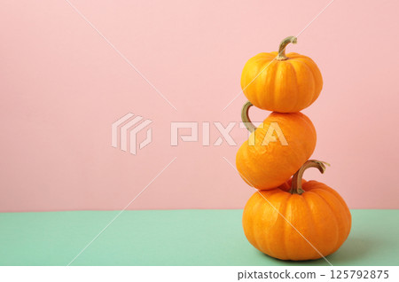 Thanksgiving and Autumn decoration. Mini pumpkins on colorful background. Thanksgiving and Autumn decoration. Mini pumpkins on colorful background. 125792875