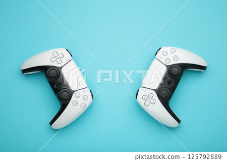 Mykolaiv, UKRAINE - July, 2024: Presentation of a new product from Sony, gamepad on blue background, game controller. Top view Mykolaiv, UKRAINE - July, 2024: Presentation of a new product from Sony, gamepad on blue background, game controller. Top view 125792889