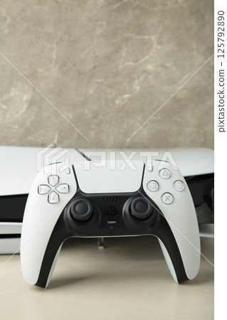 Mykolaiv, UKRAINE - July, 2024: Presentation of a new product from Sony, wireless white console PlayStation 5 and gamepad on light background, game console Mykolaiv, UKRAINE - July, 2024: Presentation of a new product from Sony, wireless white console PlayStation 5 and gamepad on light background, game console 125792890