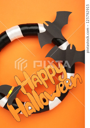 Halloween wreath on orange background. Thanksgiving decor. Vertical photo 125792915