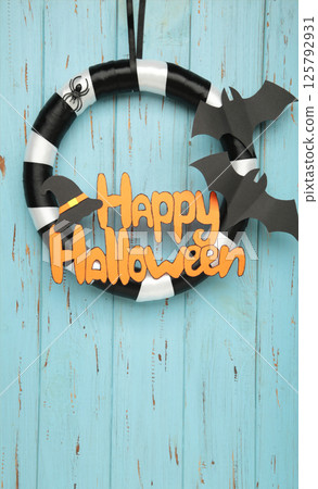 Halloween wreath on blue wooden background. Thanksgiving decor. 125792931