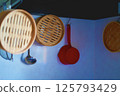 Cooking utensils hanging on the wall 125793429