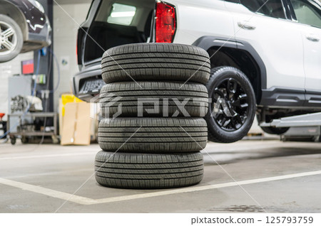 Changing tires for a car according to the season.  125793759