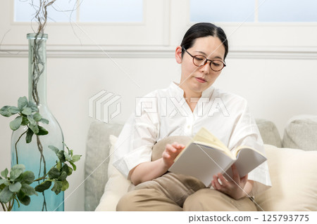 Well-bee woman reading on sofa | Study | Hobby | Healthy living image | Well-bee girl | Well-being 125793775