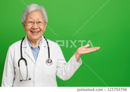 Elderly Asian female doctor presenting on chromakey 125793798