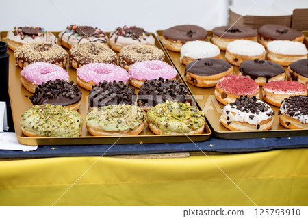 Assorted Donuts on Gold Metal Trays 125793910
