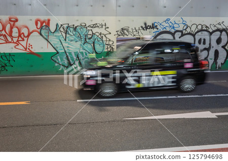 A taxi running on the Shinjuku University Guard 125794698