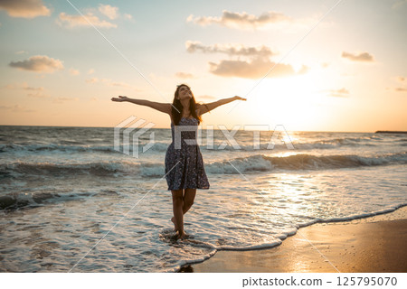 Smiling carefree woman on the beach. 125795070