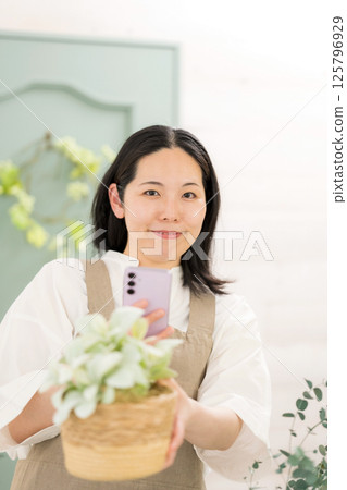 中年婦女在室內拍攝植物 |花店園藝店教室圖片|幸福女孩 |福利 中年婦女在室內拍攝植物 |花店園藝店教室圖片|幸福女孩 |福利 125796929