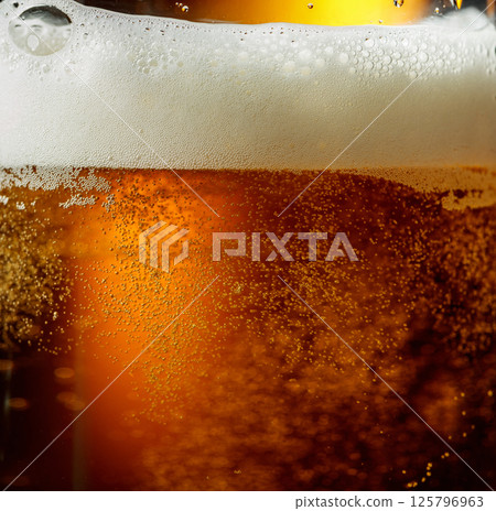 Glass of beer with foam, closeup. Glass of beer with foam, closeup. 125796963