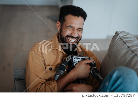 Handsome man hugging small robot like real friend 125797297